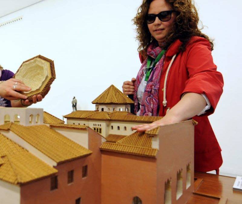 Una usuaria tocando una de las piezas de la exposición